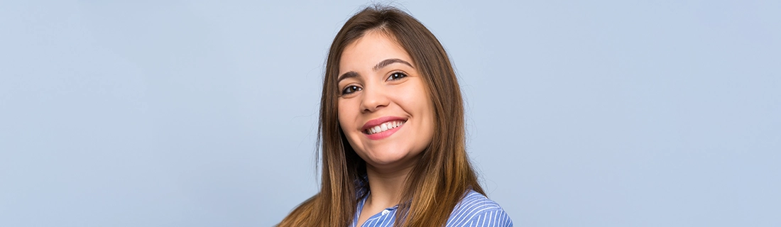 Dentist Sacramento CA Woman Smiling On Light Blue Background Dentist Sacramento CA Woman Smiling On Light Blue Background