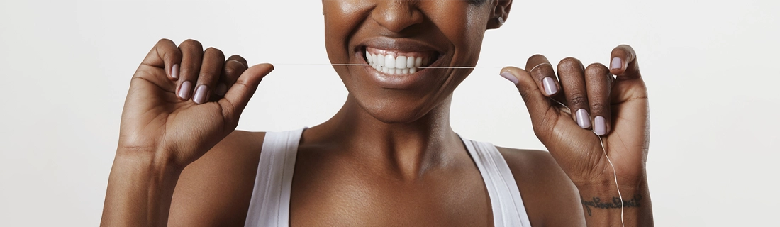 Dentist Sacramento CA Woman Flossing Teeth