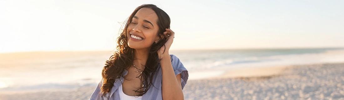 Dentist Sacramento CA Woman Smiling On The Beach